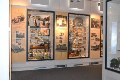 Two display cases showing objects in the museum are surrounded by panels with information.